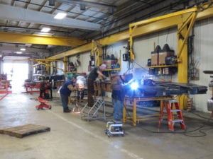 Weld Production Team in Bay 40 welding on a hydraulic detachable gooseneck trailer