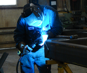 Felling Trailers Parts & Service Tech welding on a trailer component Felling_Trailers_Parts_Service_Tech