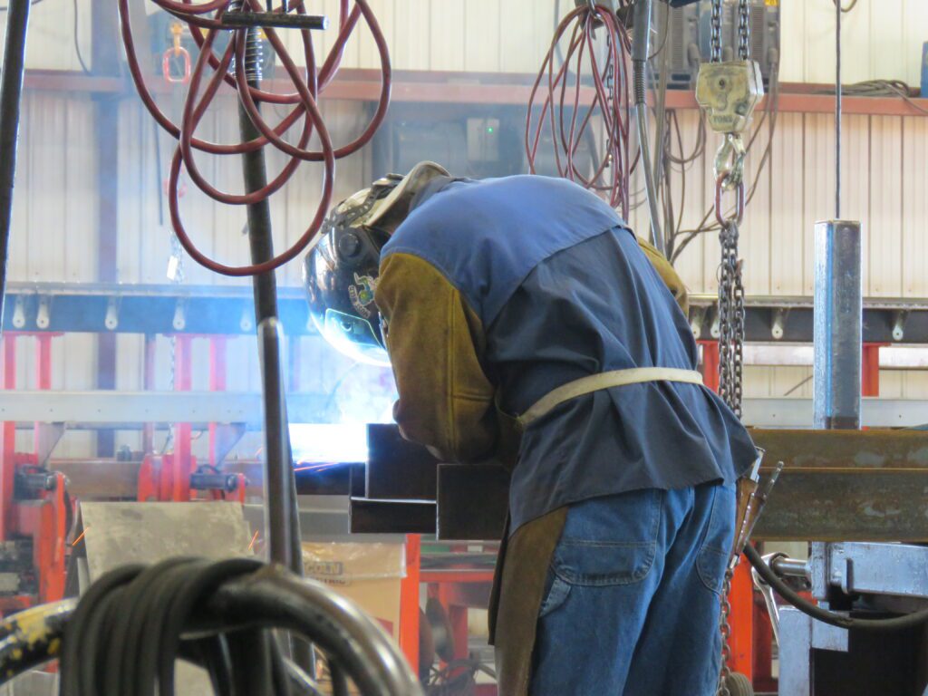 Employee welding at Felling