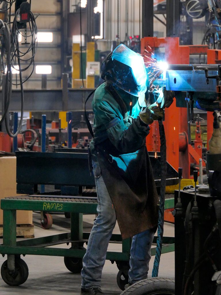 Person welding trailer parts. 