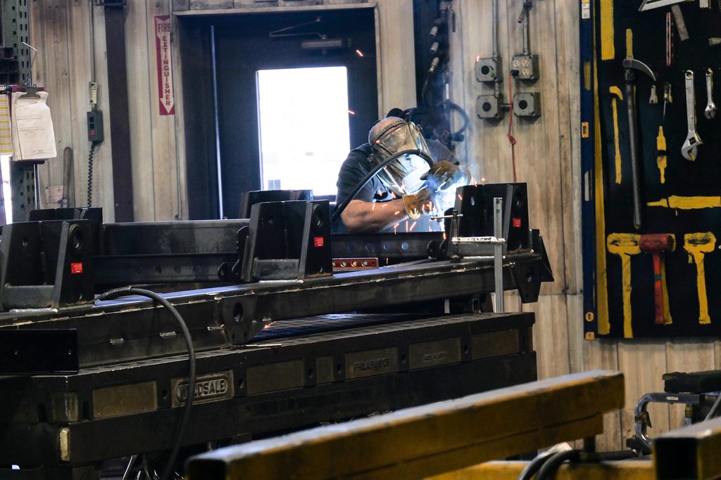Man welding a trailer. 